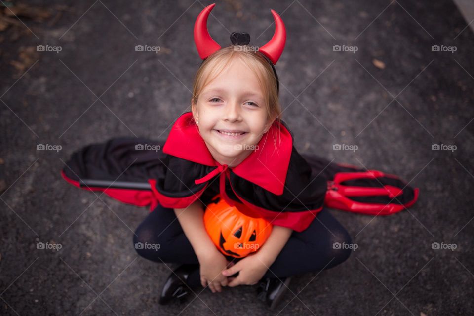 Happy kid celebrating Halloween outdoor 