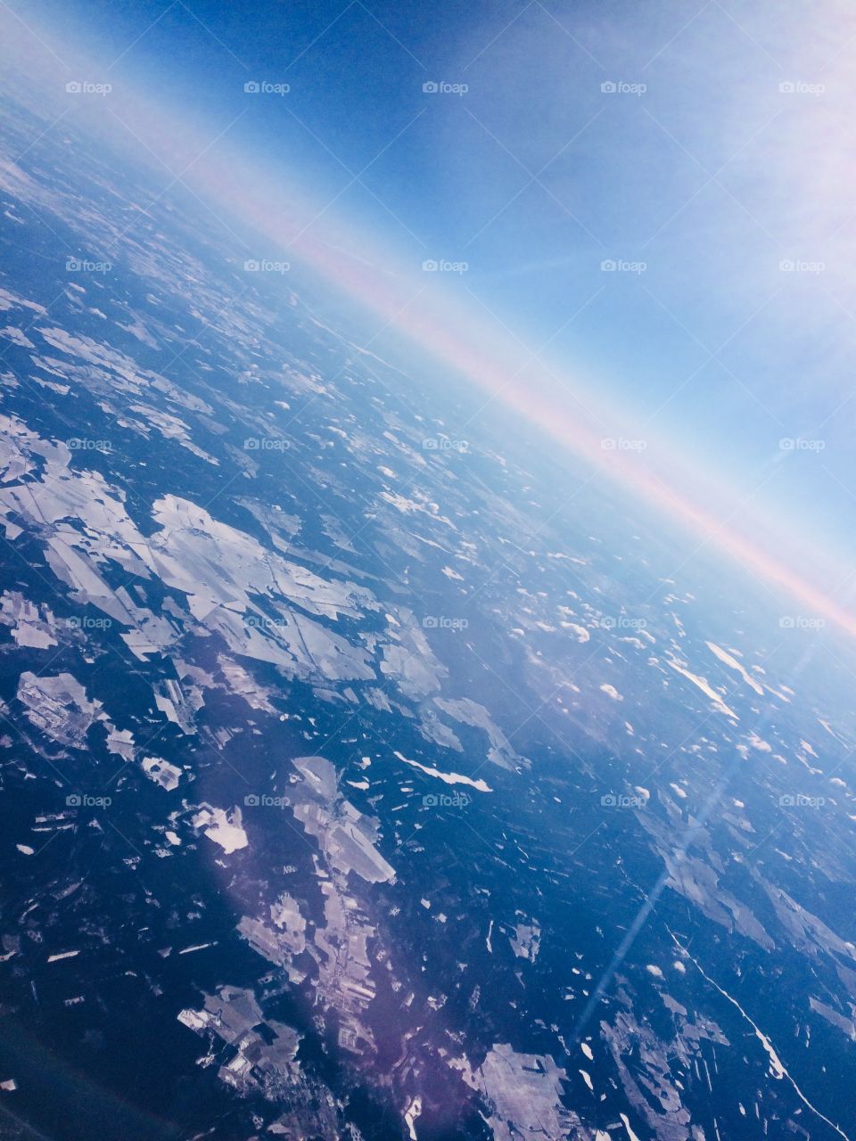 A view from the airplane to the horizon and the ground above