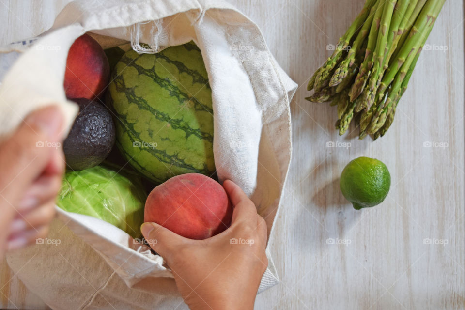 Using cloth bag for shopping fruits and veggies.