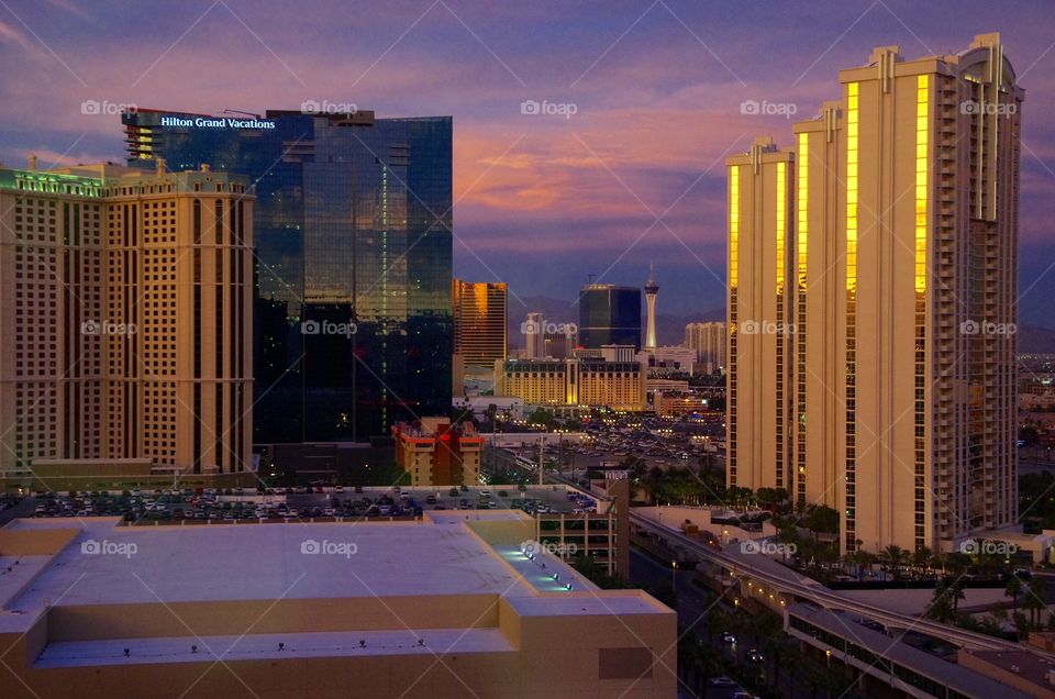 Exterior daylight.  Las Vegas, NV, USA.  The city’s towers reflect the setting sun.