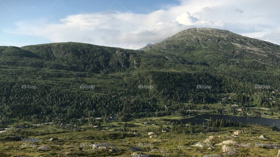 This is a picture taken in the beautiful nature in Norway (Country in Europe). The picture is taken from a mountain, facing some bigger mountains. This is approximately 600 meters above sea level.
