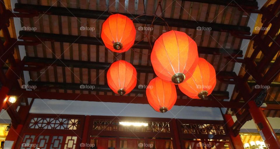 Interior of Chinese wooden building with red lanterns