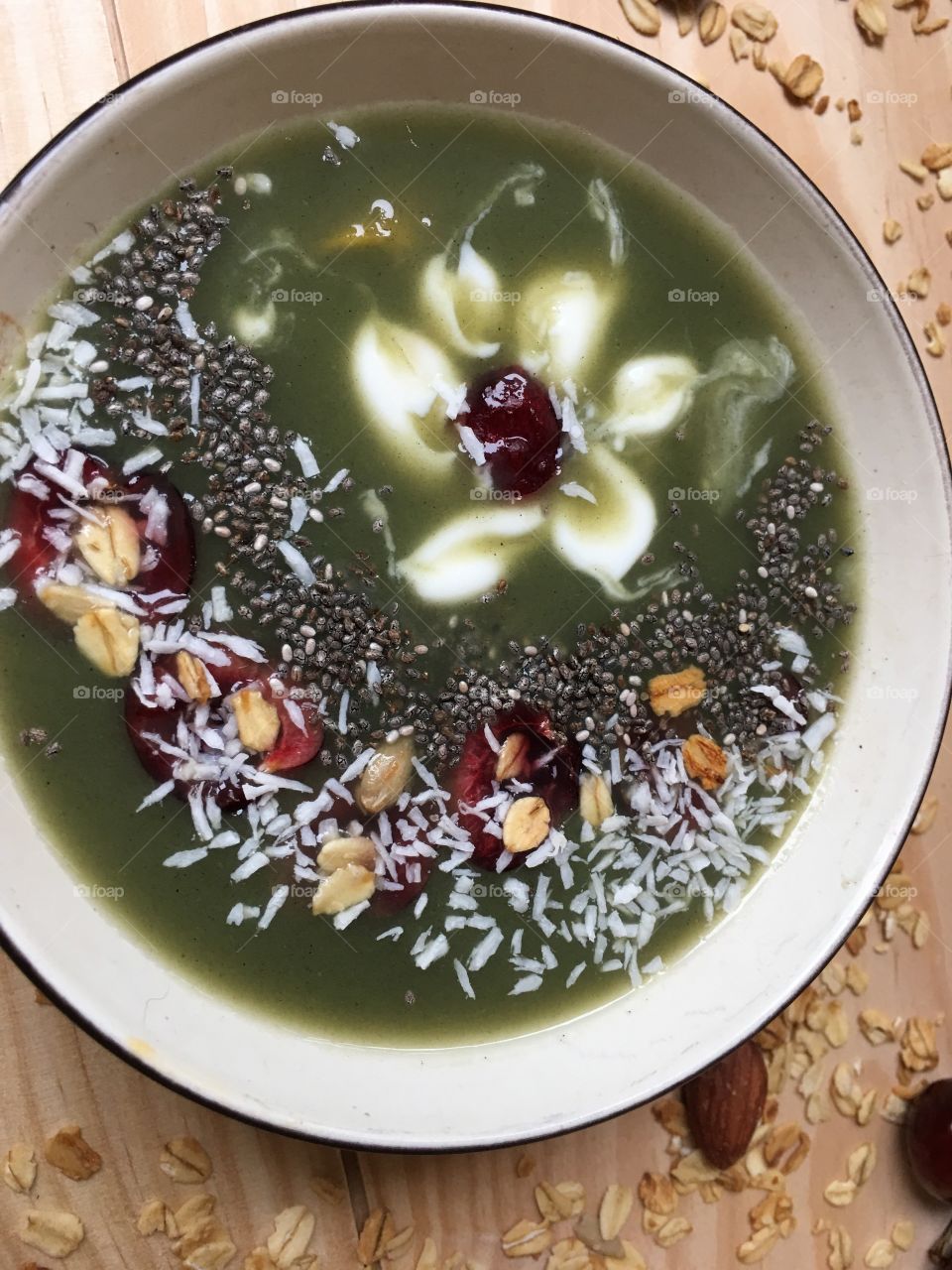 Green Cherry Almond Smoothie with zen cherry blossom flower design, coconut, chia and oatmeal inspirational healthy eating smoothie bowl design photography vertical background part of a series 