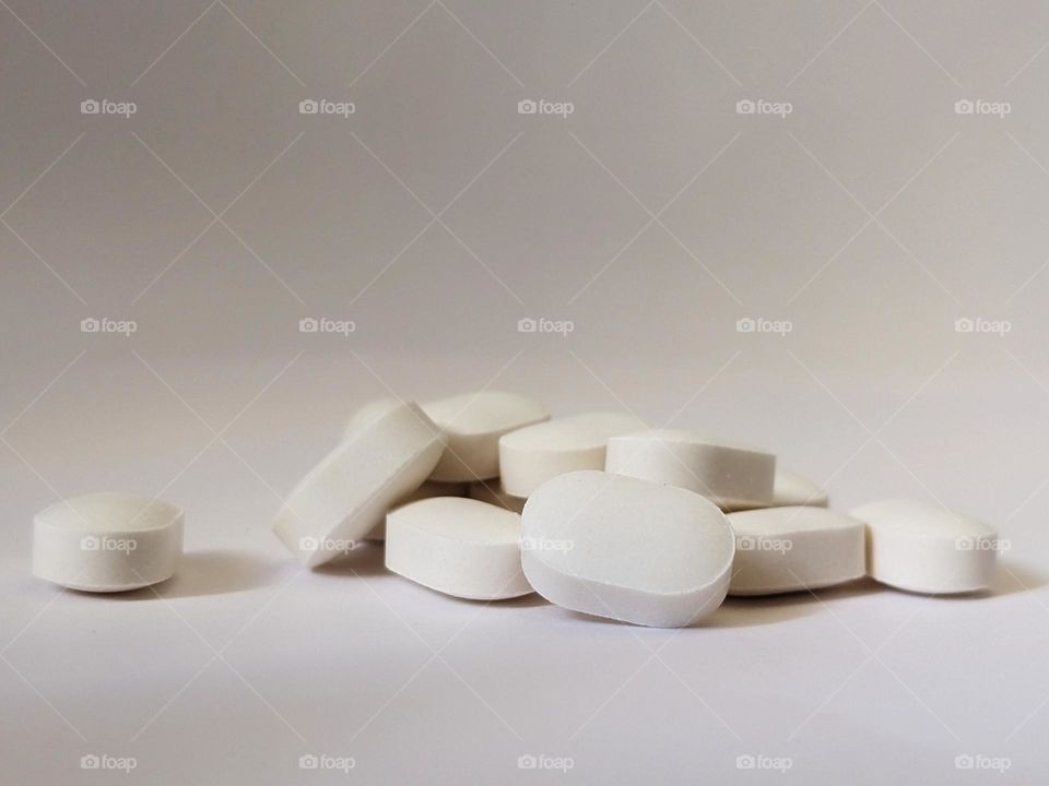 white medicines on isolated white background