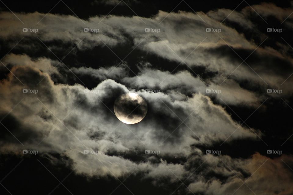 Storm clouds over the moon