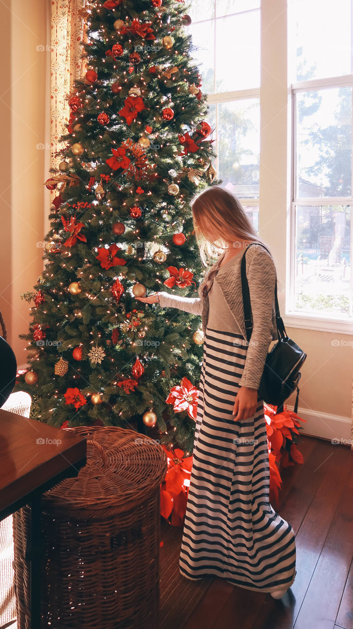 Young woman beside Christmas tree 