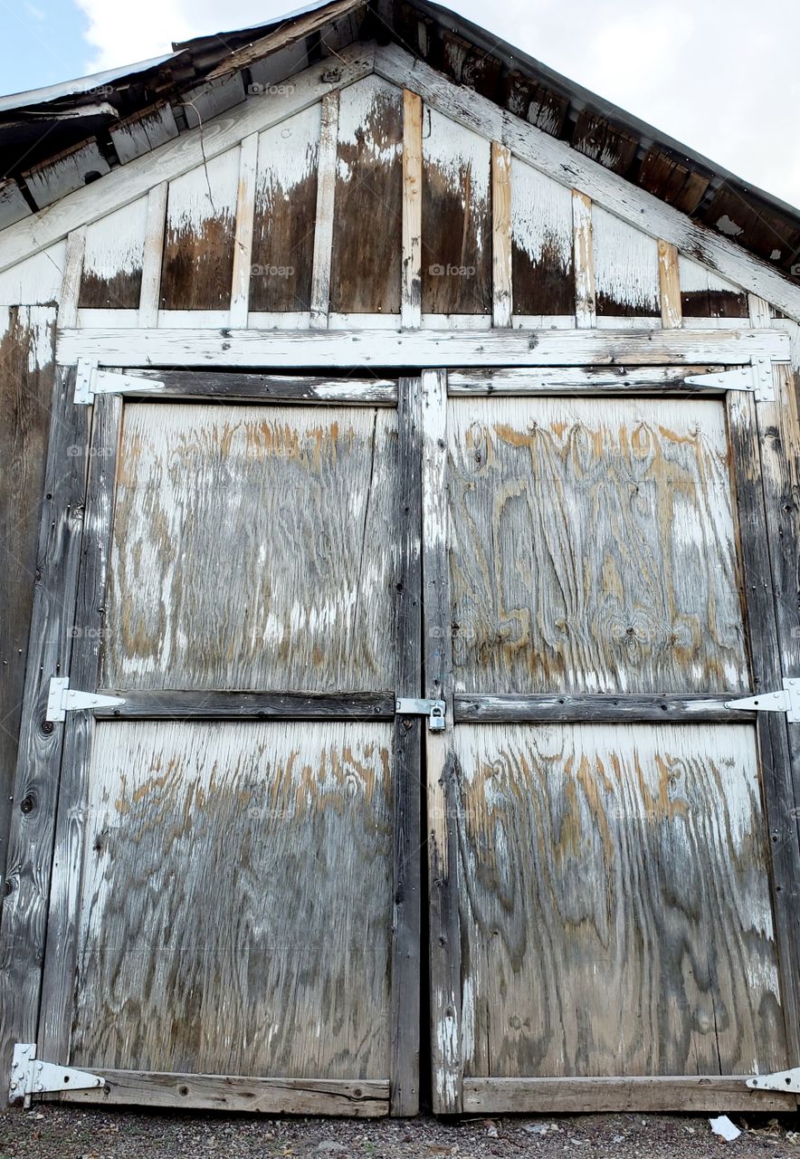 A weathered wooden door has lots of character and makes one wonder what secrets are contained behind the lock.