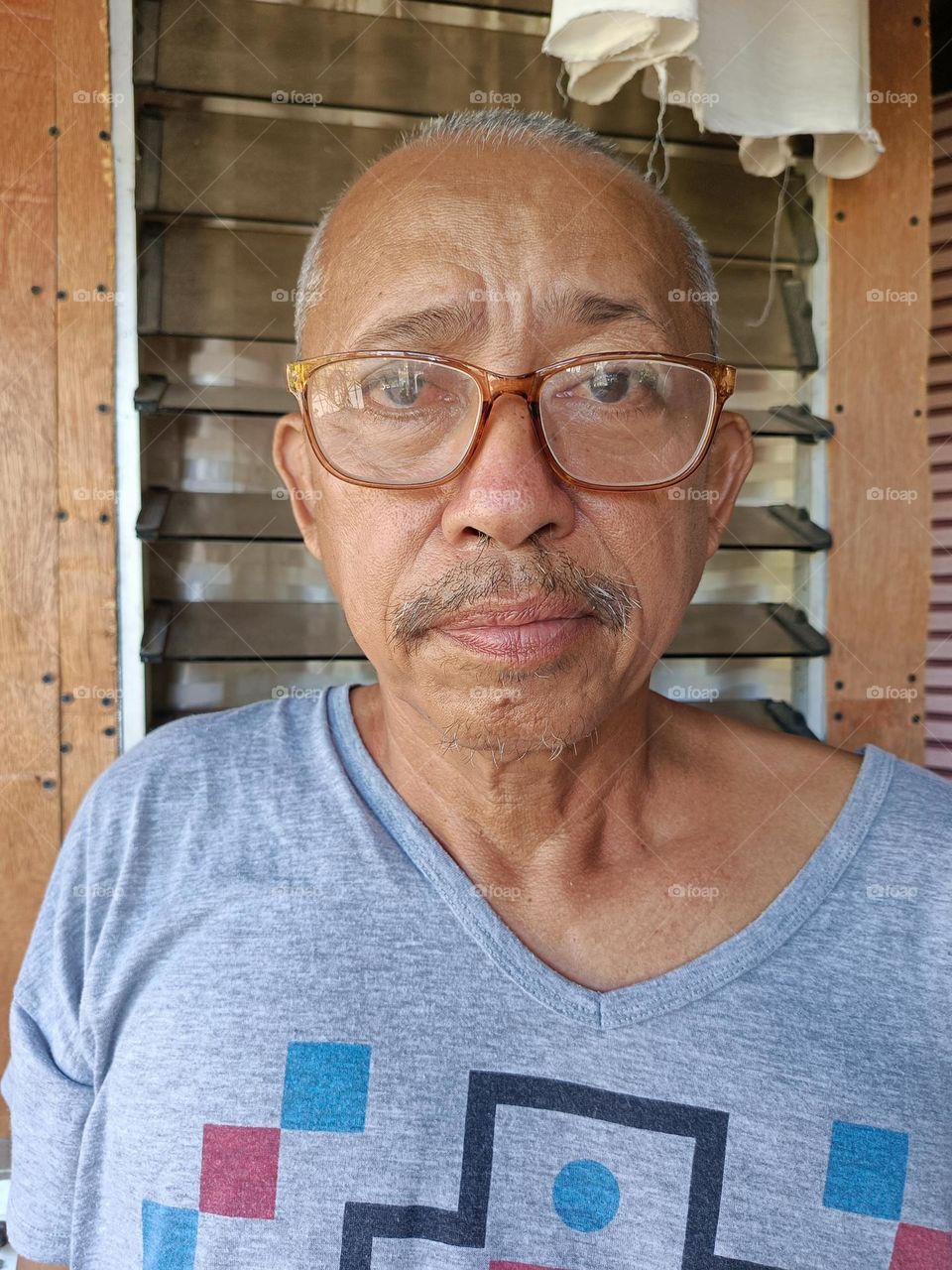 "A subtle mustache, a mark of character and quiet confidence, adding depth to his calm and steady expression."