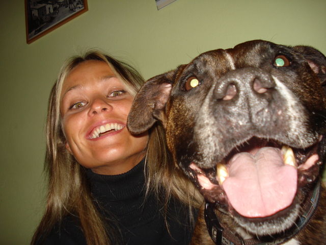 Young girl and a dog with mouth open looking at camera