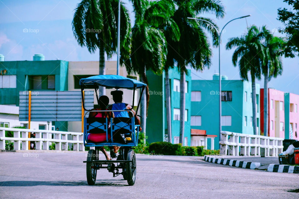 Lovely Couple With Electric Tricycle In Santiago De Cuba
