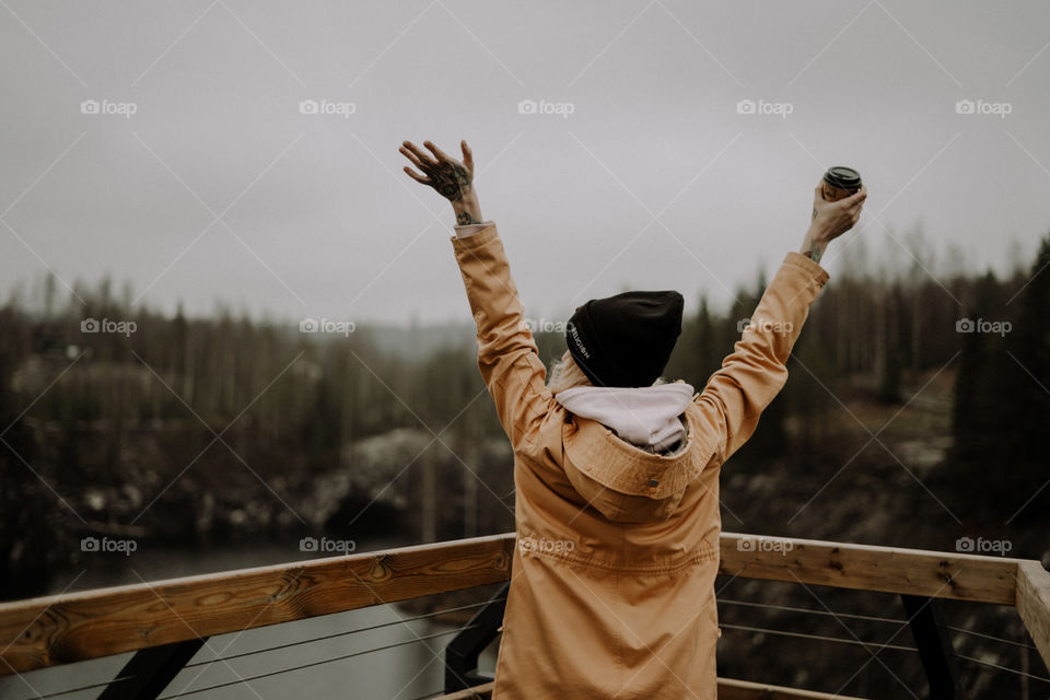 woman wearing yellow parka in the woods, freedom