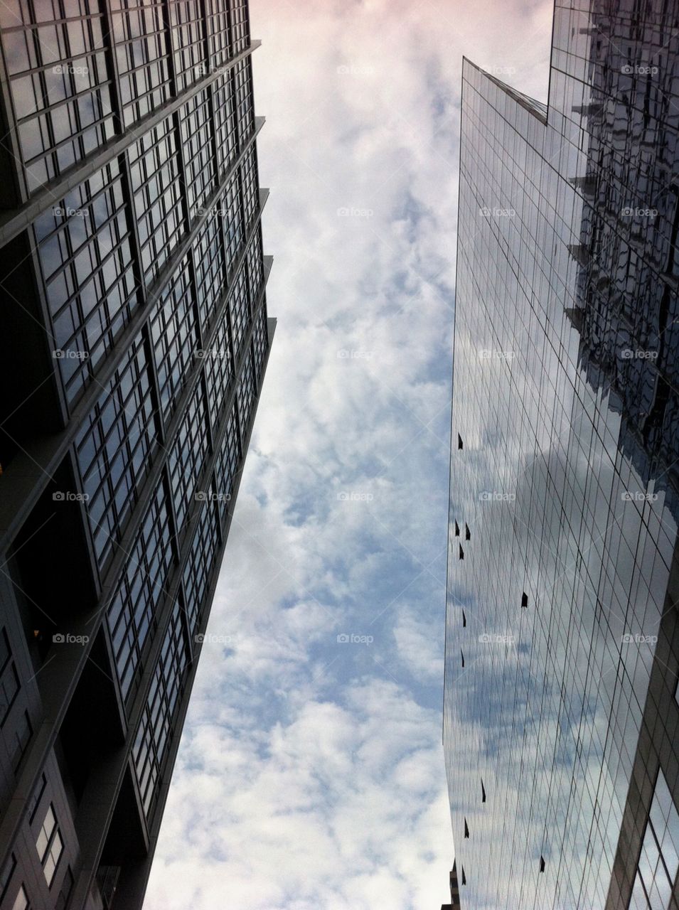 The Upper-room . Reflections of the Boston sky looking up between two buildings near Four Point Channel 