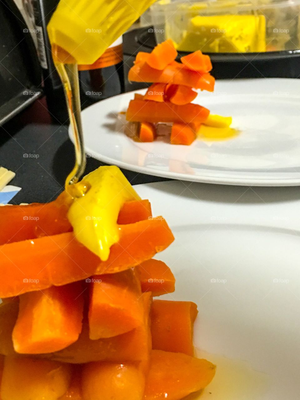 Maple
Syrup glazed carrots shown here while prepping plates, stacked 