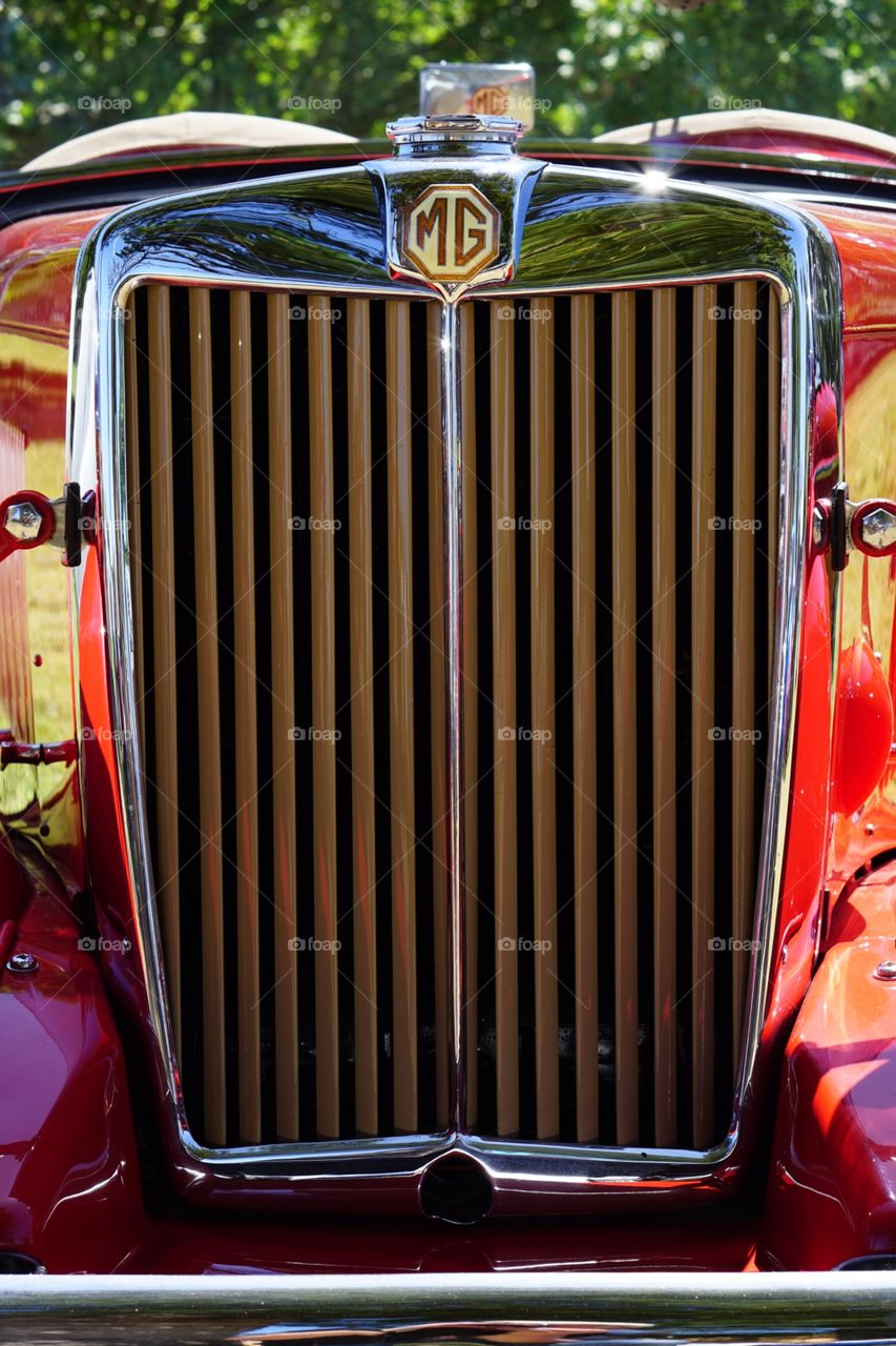 MG car grill. Grill from a red MG car macro chrome