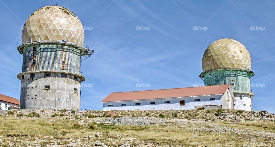 The old Observatory towers at Serra Da Estrela, under a blue sky