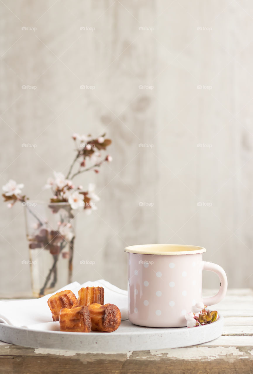 Still life made by mug and some pastry. Copy space.