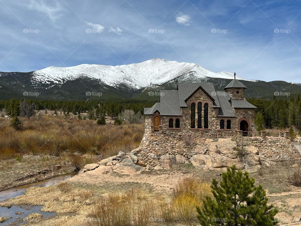 A beautiful view of charming chapel surrounded by the Rocky Mountains 