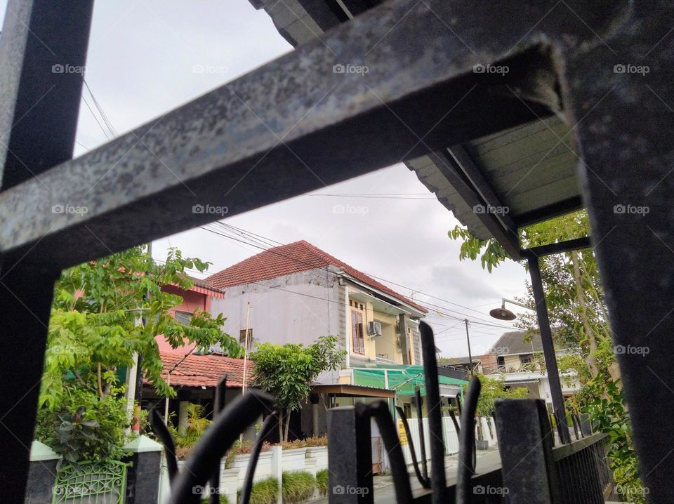 From behind the iron fence