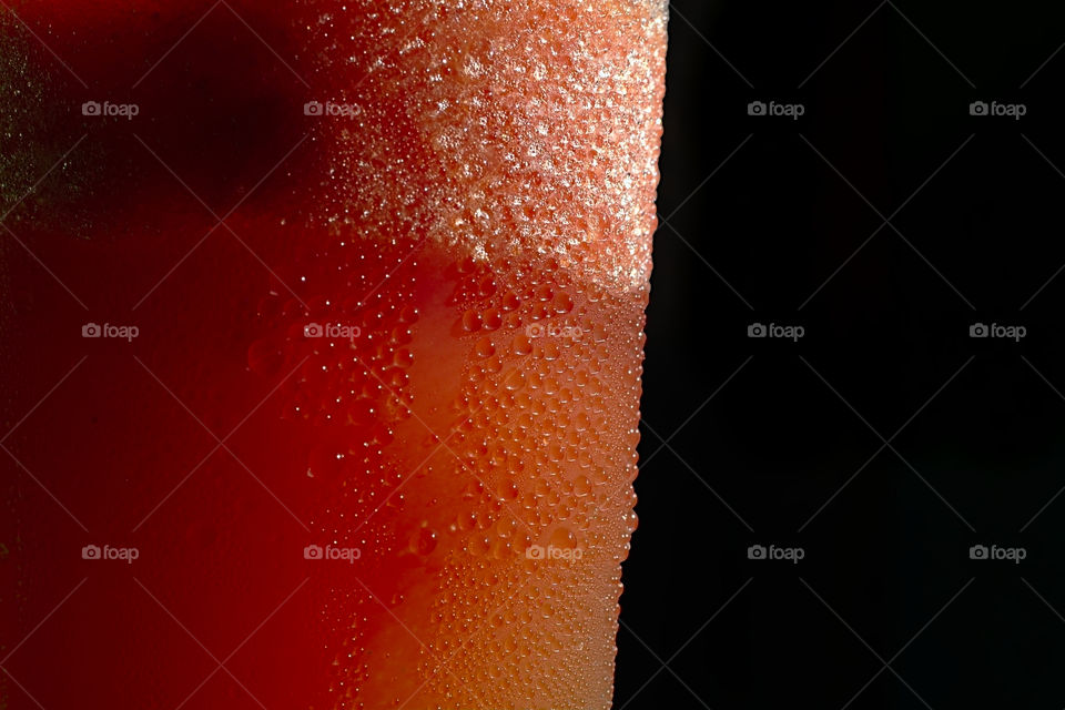 Condensation or dews forming on the cup of a fruit shake.
