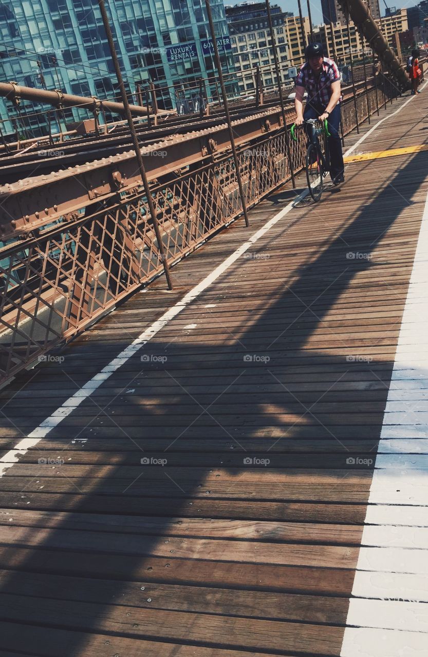 Cyclist crossing Brooklyn Bridge 