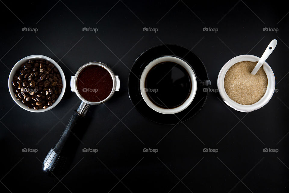 Coffee making process from bean espresso cup and sugar. Flat lay for circle and ellipse shapes. Close up symmetry on black background. Love coffee!