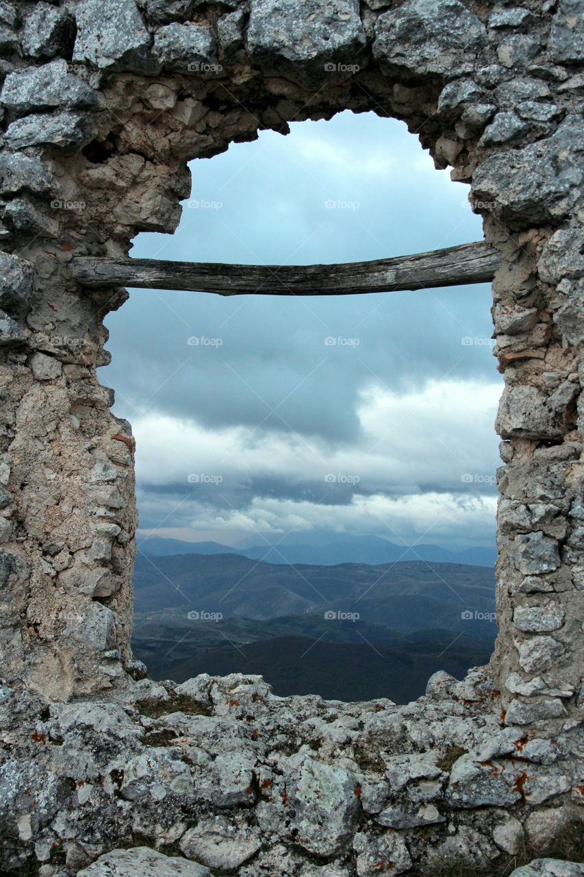 view of stormy and cloudy sky, through a window