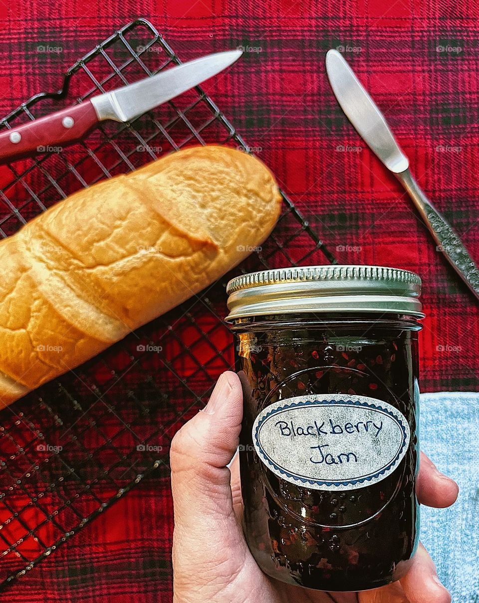 Blackberry jam and homemade bread, loaf of bread with blackberry jam, canning and baking at home, jam and bread at home, delicious bread at home, baking at home, making bread at home for your family 