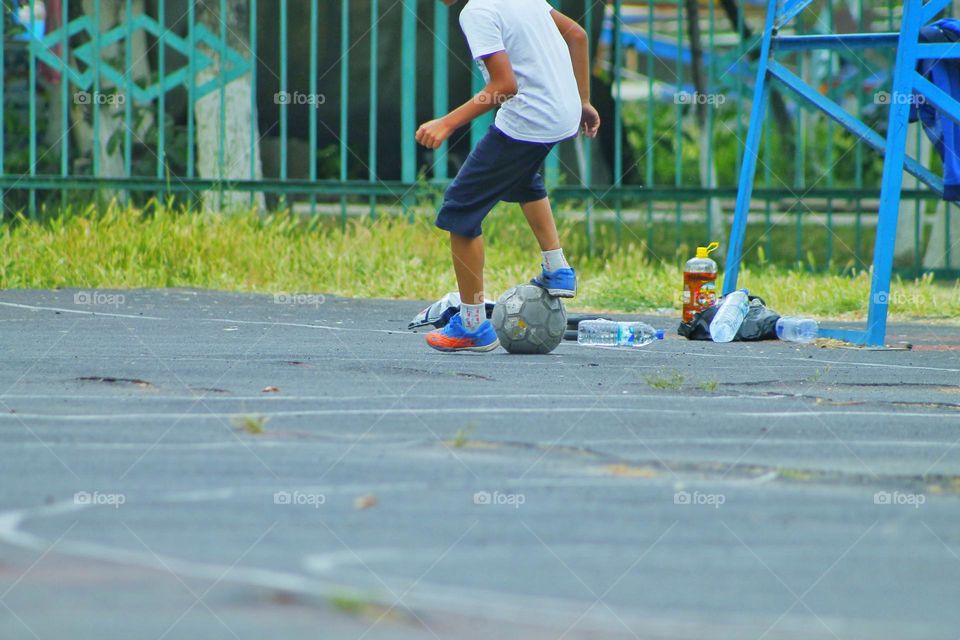 children in the old stadium play football.