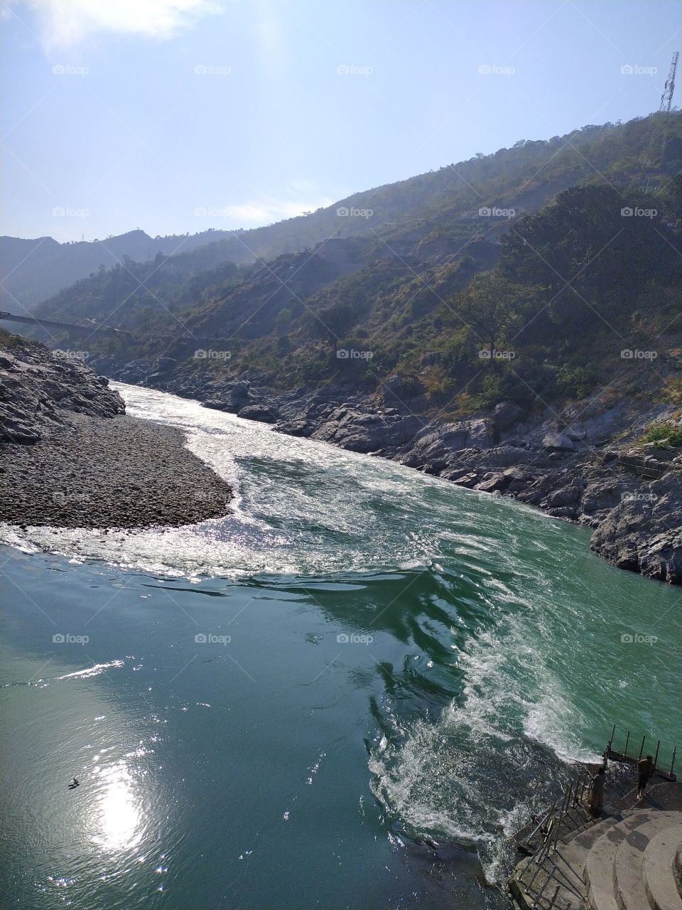 Rays of the winter sun playing on the green waters of the sacred rivers Alaknanda, Bhagirathi and the Ganga