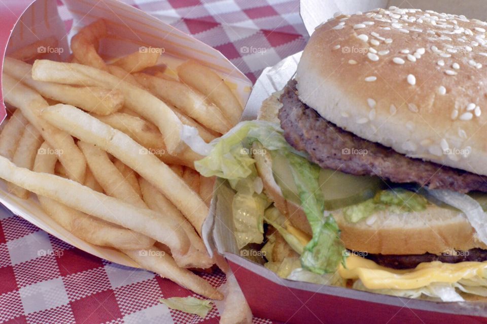 McDonald’s Big Mac, fries and drink on a red a white checkered background 