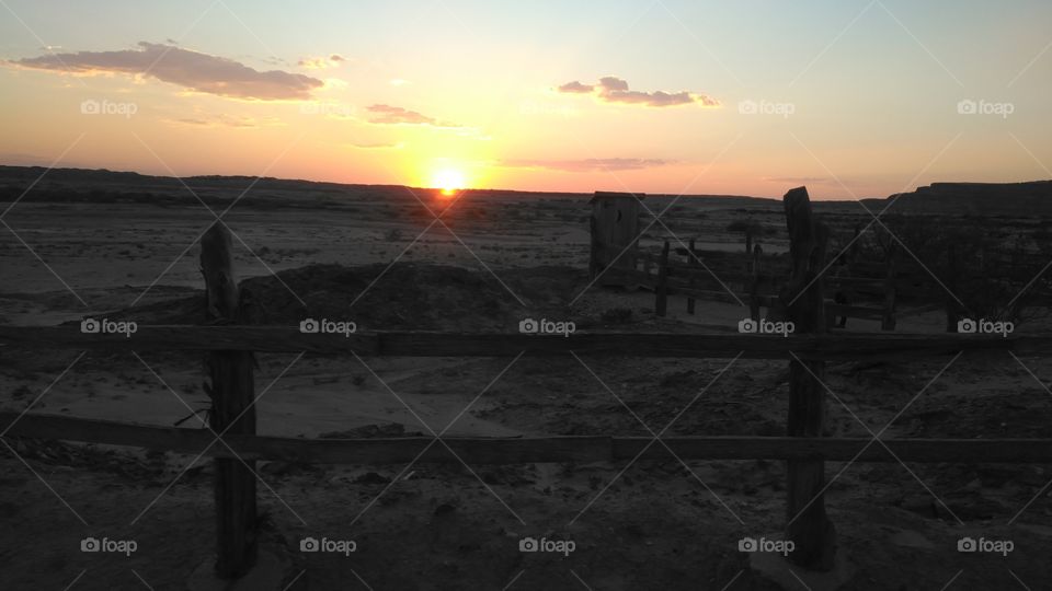 sunset at old desert house fence