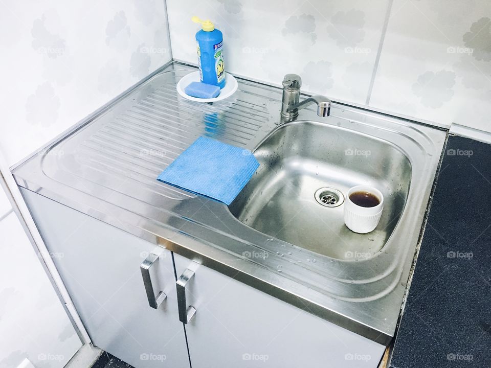Kitchen sink with coffee cup inside