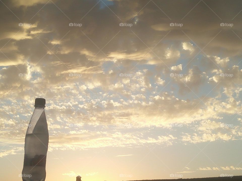 Scenic sky and a bottle embraces high sky.