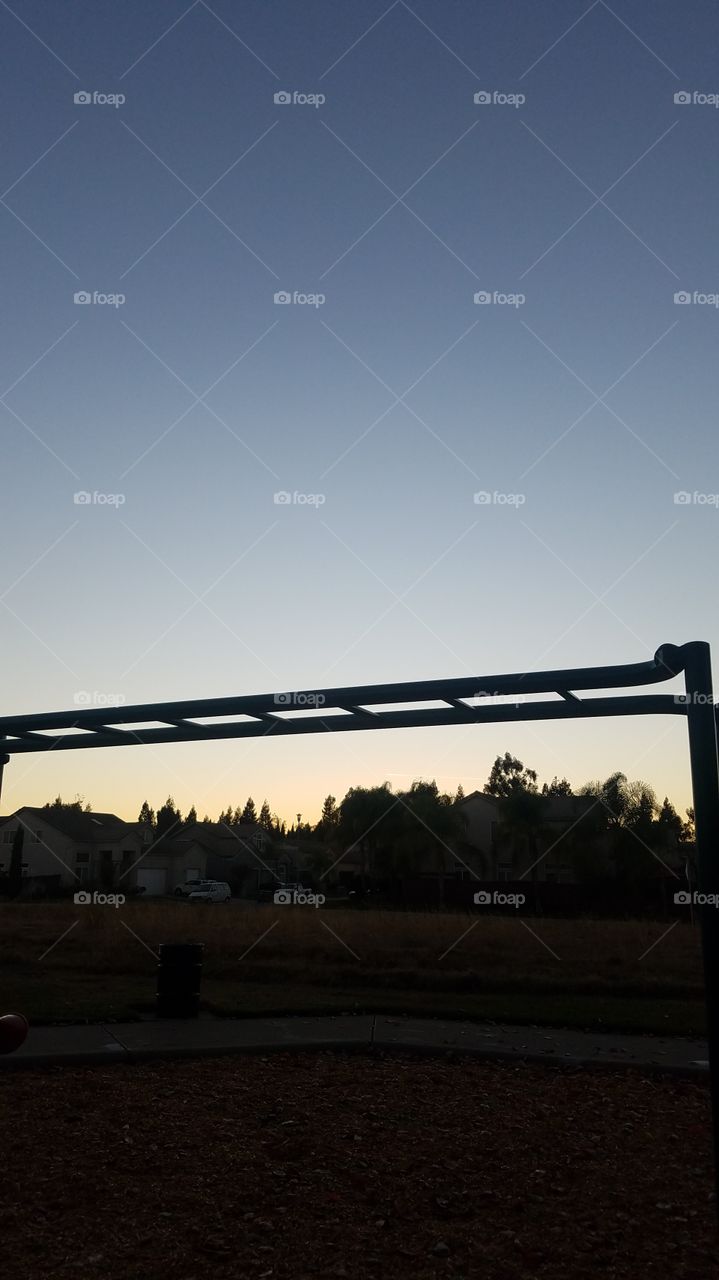 Monkey bars, trees, and a sunset. The recipe for a family friendly photo. There is no better way to capture a playground than this!
