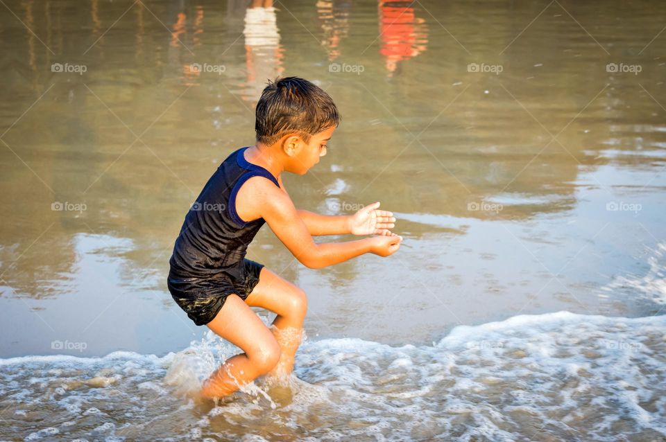 Playing in beach. Cool way to escape from hot summer.