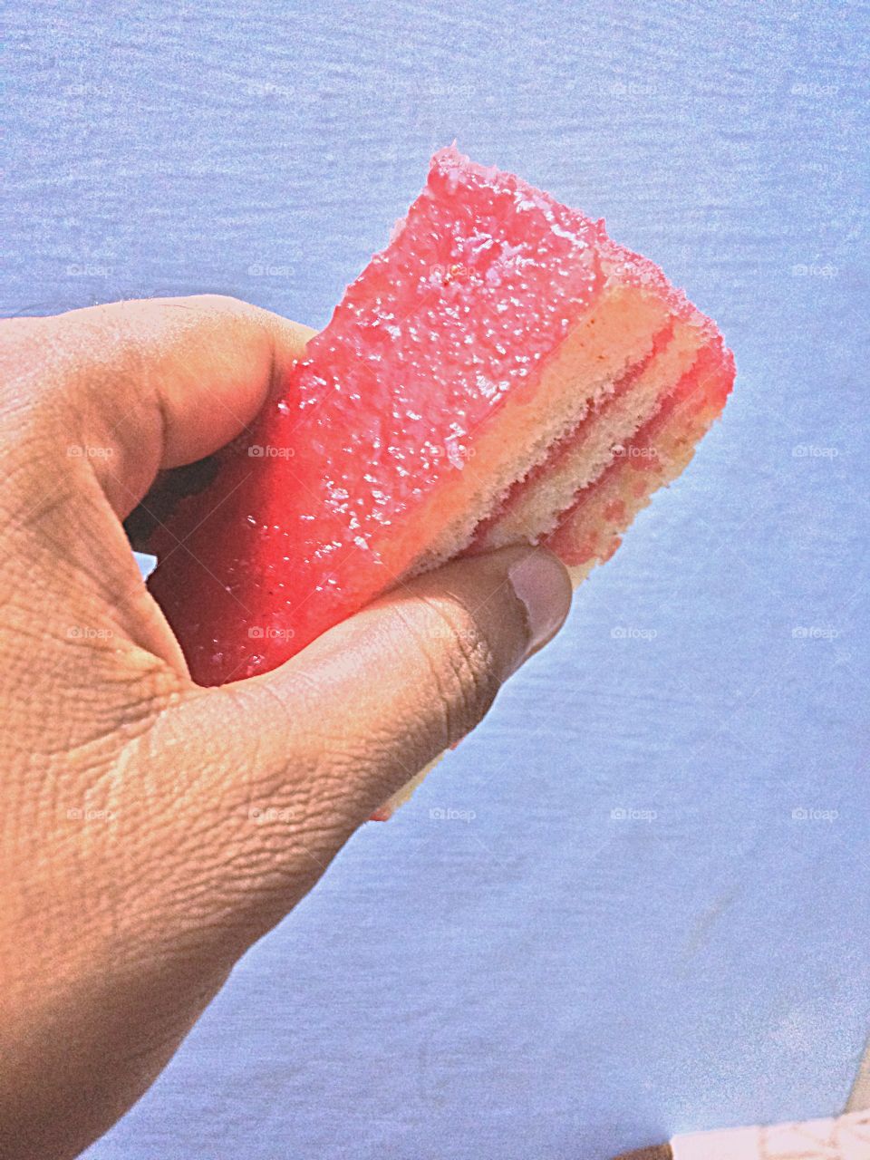 Close-up of a hand holding cake