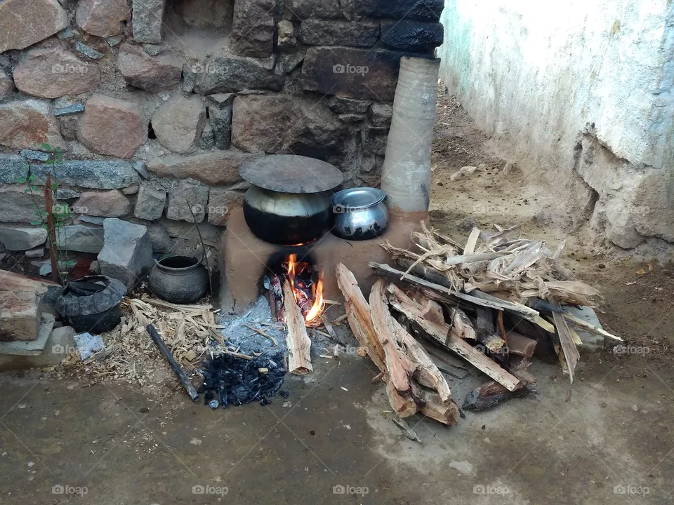 In India Remote Areas Old style of cooking.This is the style what they prefer to cook food naturally.Fresh Air and Lavish life are pushing their life to great extent.Everything had made of natural process and eco friendly way.Accessing to moderns their life style and food habits are just disgusting and unbearable way.Their Life span could be reducing due to these reasons.In Picture you have seen a mud stove constructed by my grandma.It has been constructed before 2 years.They use fire source as Cow dung plates.These cow dung plates are eco friendly to nature and termite resistant.These are the visuals captured in my grandma Village.