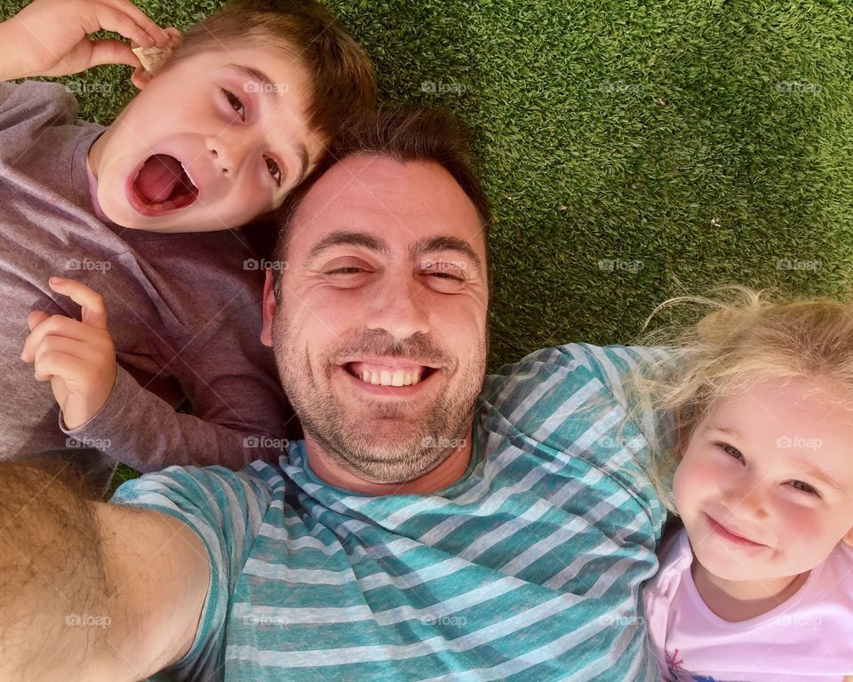 Father and children taking selfie