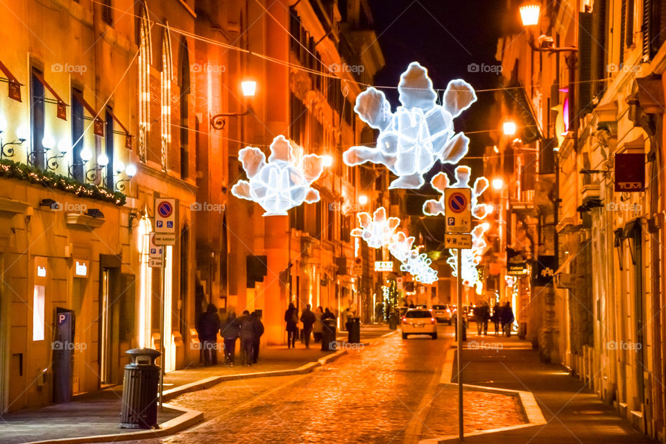 People Night Out In Christmas Decorated Street
