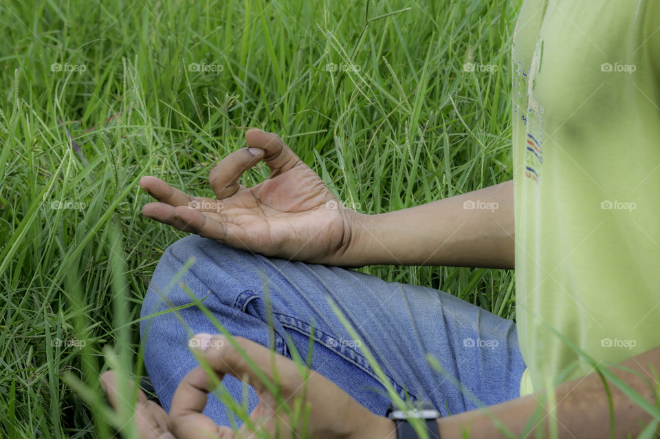 Close up hands, yoga outdoor, exercising vital and meditation for fitness at the nature background. Healthy and Yoga, zen relaxation nature background. Healthy Lifestyle Concept. (Kolkata, India)