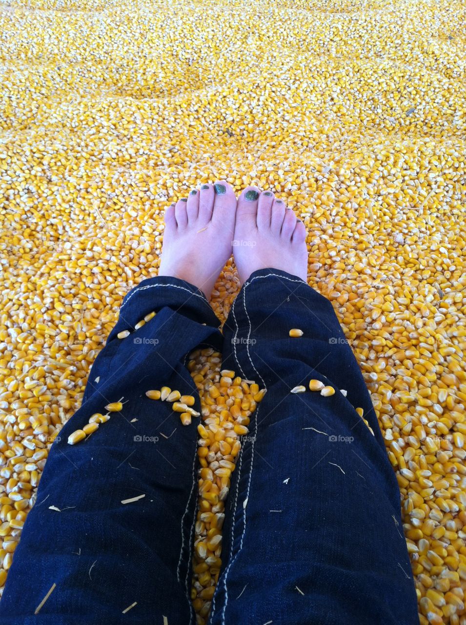 Painted toes in a corn pit
