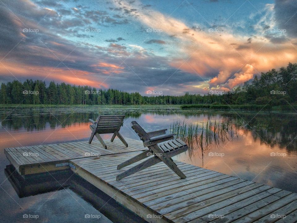 Wooden chairs on pier