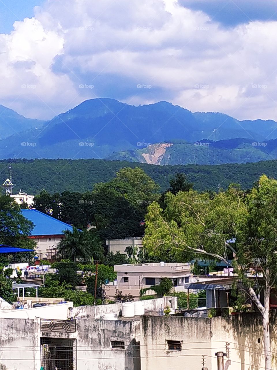Beautiful autumn afternoon in the Himalayan foothills. Beautiful Mussoorie hills on the backdrop with residual monsoon clouds in the sky
