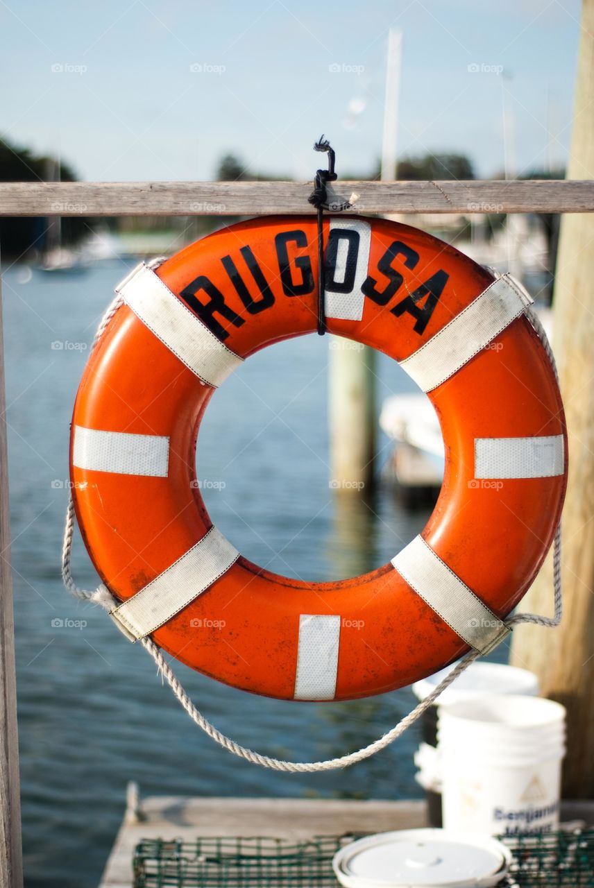 Orange and White Life Saver Float on Dock in KennMaine