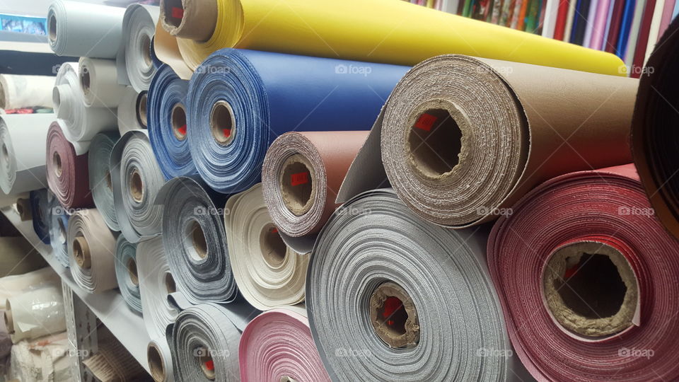 rolls of fabric stacked on each other.