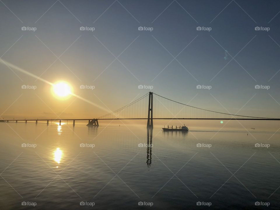 Baltic Sea with bridge and ship on a golden sunset