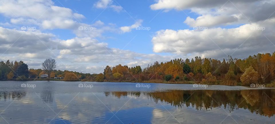 beautiful nature landscape lake shore blue sky clouds background