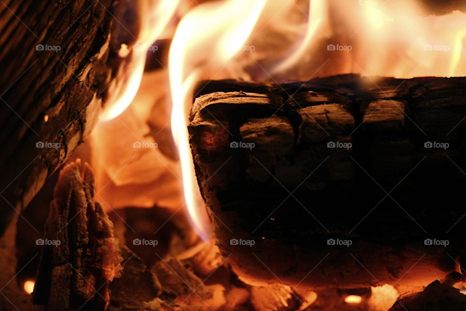 close up of log burning in a fireplace