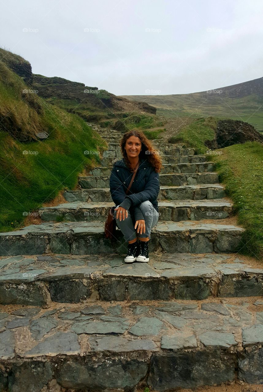Smiling woman sitting on staircase