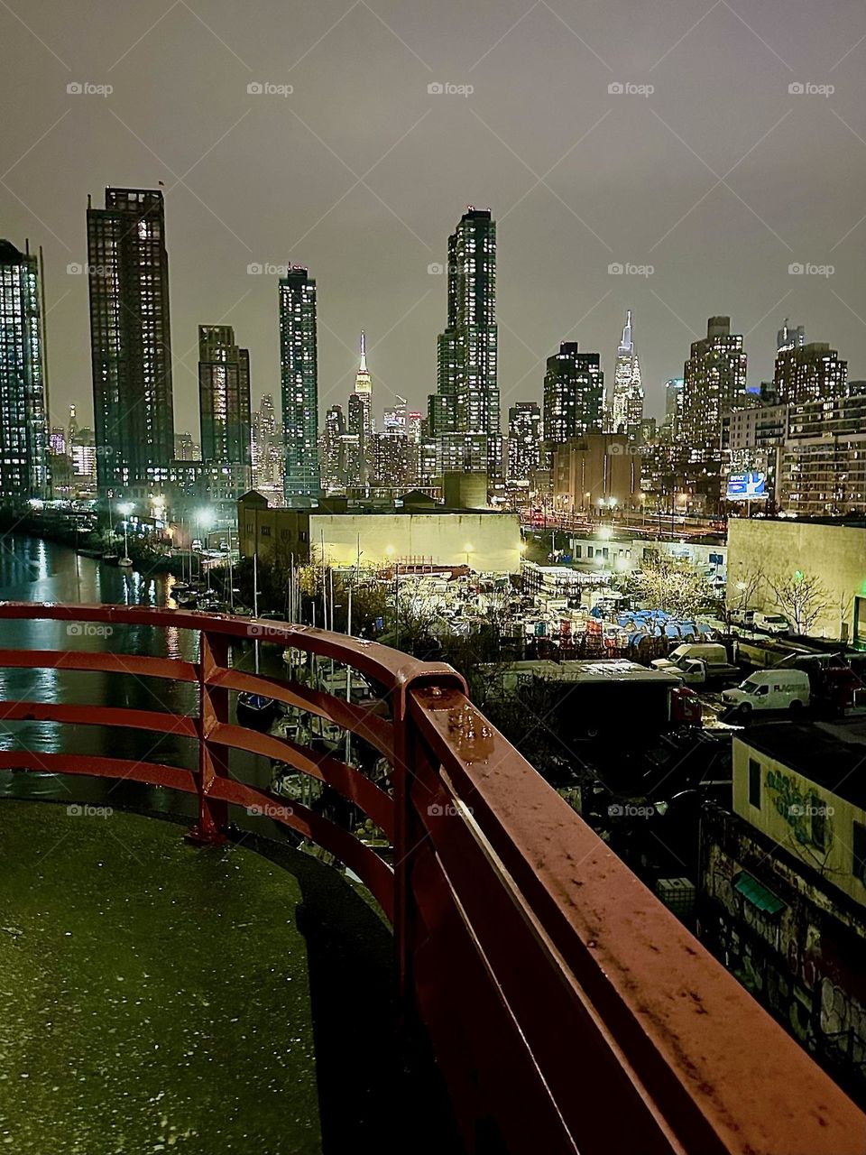 This is a view of “Newtown Creek” from the “Pulaski Bridge” that connects “Greenpoint”, Brooklyn and LIC, Queens on an evening in December 2023. “Manhattan” including the “Kreisler” and the “Empire State Building” can be seen. Hypnotic Productions